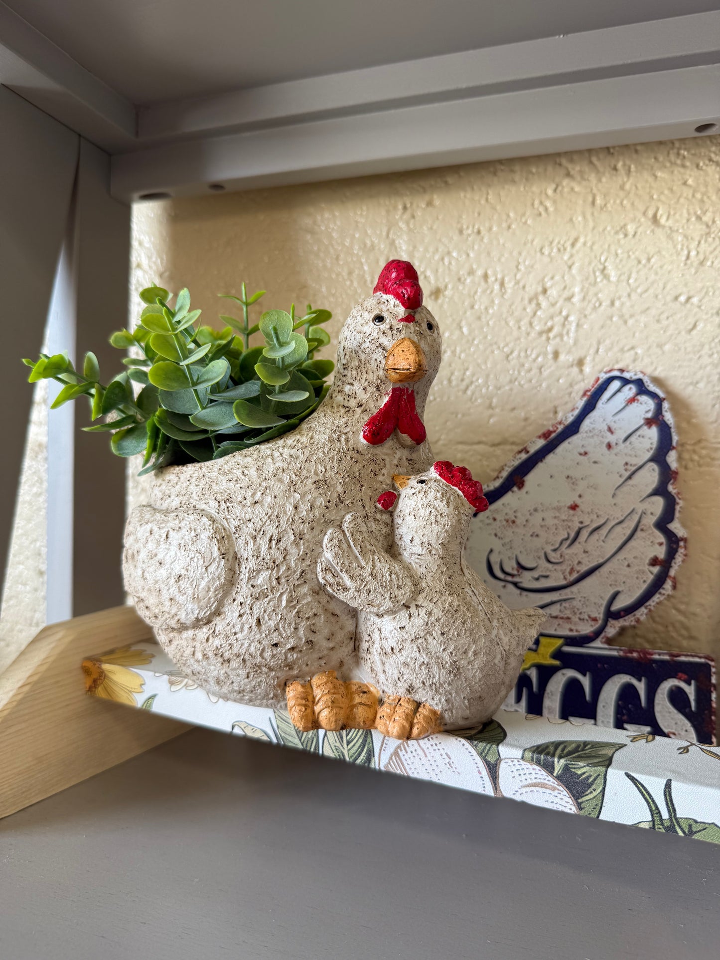 Ceramic chicken figurine with fake plant