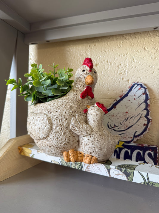 Ceramic chicken figurine with fake plant
